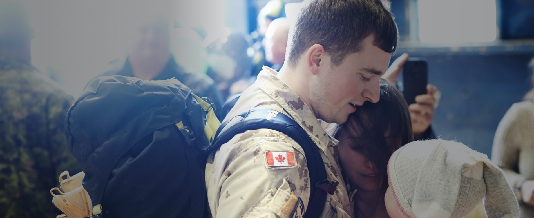 Male soldier reunites with young child on return from deployment